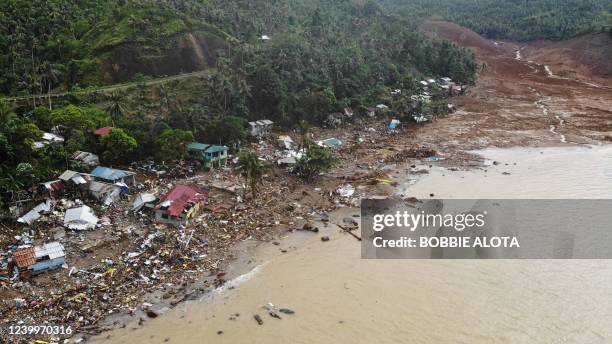 An aerial view shows destroyed houses on a collapsed mountain side along the coastline in the village of Pilar, Abuyog town, Leyte province on April...