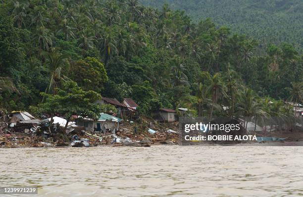 An aerial view shows destroyed houses and a collapsed mountain side along the coastline in the village of Pilar, Abuyog town, Leyte province on April...