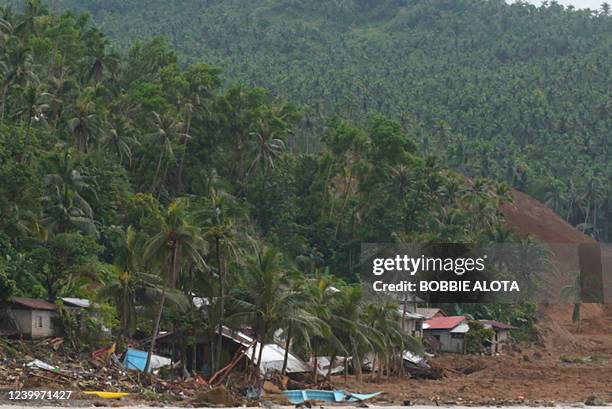 An aerial view shows destroyed houses and a collapsed mountain side along the coastline in the village of Pilar, Abuyog town, Leyte province on April...