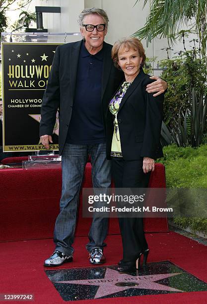 Actor Gary Busey and Maria Elena Holly pose for photographers during the ceremony for recording artist Buddy Holly's posthumous star on the Hollywood...