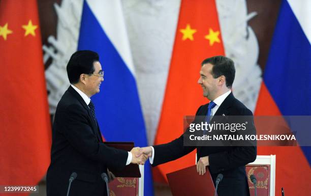 Russian President Dmitry Medvedev shakes hands with his Chinese counterpart Hu Jintao during a signing documents' ceremony in the Moscow Kremlin, on...