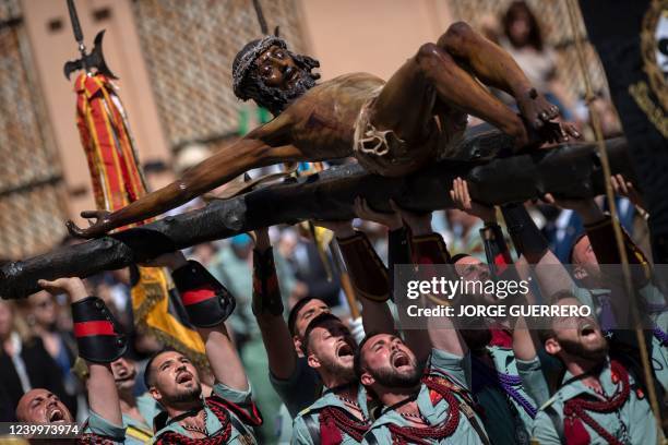 Spanish legionnaires bear a crucifix figure depicting 'El Cristo de la Buena Muerte' during the 'Cristo de Mena' Holy Week procession on April 14,...