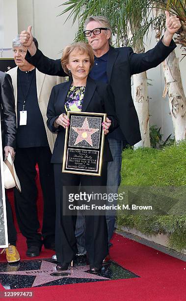 Actor Gary Busey and Maria Elena Holly pose for photographers during the ceremony for recording artist Buddy Holly's posthumous star on the Hollywood...