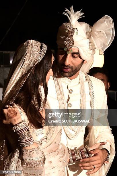 Bollywood actors Ranbir Kapoor and Alia Bhatt pose for pictures during their wedding ceremony in Mumbai on April 14, 2022.