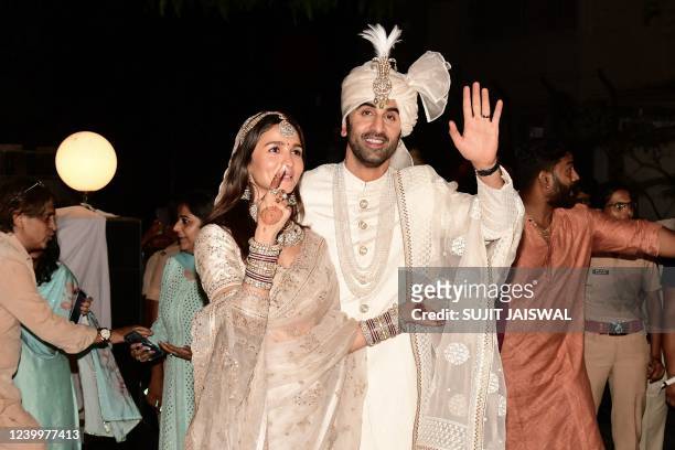 Bollywood actors Ranbir Kapoor and Alia Bhatt gesture during their wedding ceremony in Mumbai on April 14, 2022.
