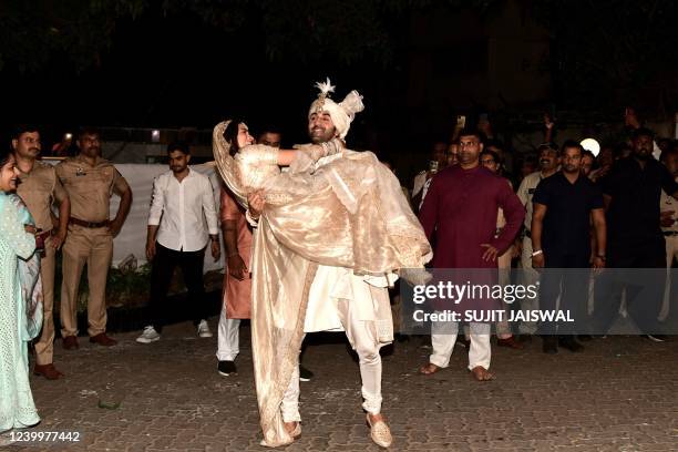 Bollywood actors Ranbir Kapoor and Alia Bhatt pose for pictures during their wedding ceremony in Mumbai on April 14, 2022.