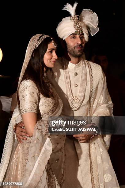 Bollywood actors Ranbir Kapoor and Alia Bhatt pose for pictures during their wedding ceremony in Mumbai on April 14, 2022.