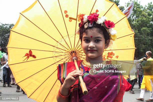 Kid poses for a portrait to celebrate the first day of the Bengali New Year or Pohela Boishakh' in Dhaka. Thousands of Bangladeshi people celebrate...