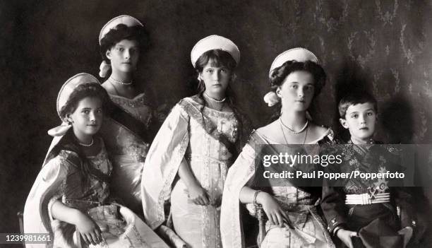 The family of Tsar Nicholas II and Tsarina Alexandra of Russia, left to right, Grand Duchesses Tatiana, Marie, Anastasia and Olga and the Tsarevich...