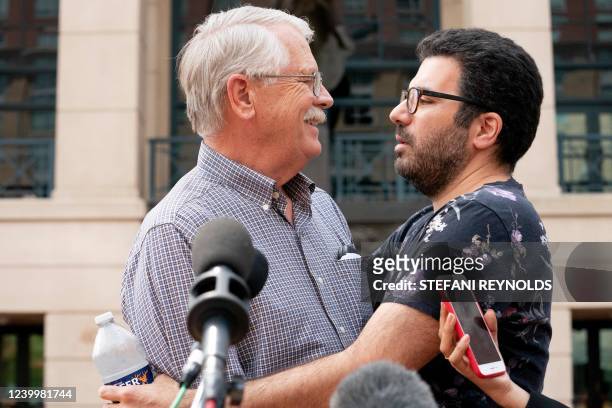 Carl Mueller, the father of Kayla Mueller, an American human rights activist slain by Islamic State militants, embraces Rodwan Safer Jalani, a friend...