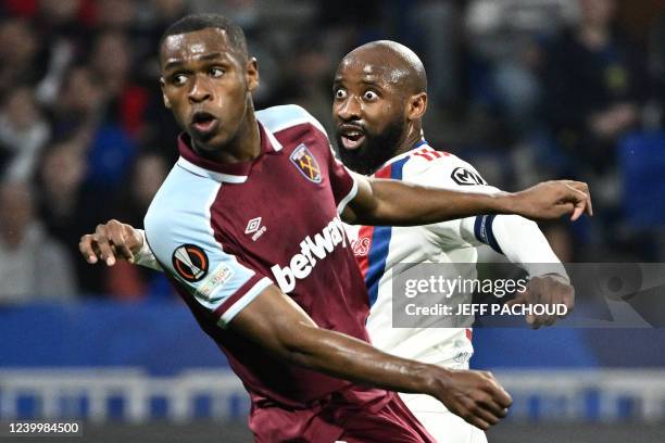 Lyon's French forward Moussa Dembele and West Ham United's French defender Issa Diop react during the UEFA Europa League quarter-final second-leg...