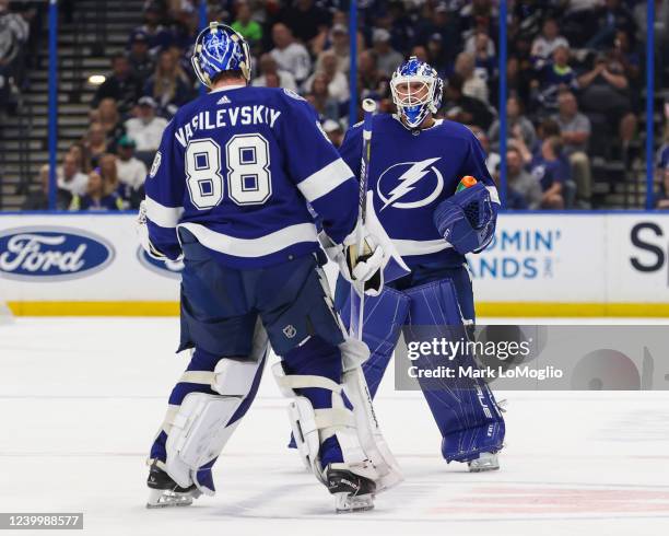 Goalies Andrei Vasilevskiy and Brian Elliott of the Tampa Bay Lightning meet at center ice after a change at the goaltender position against the...