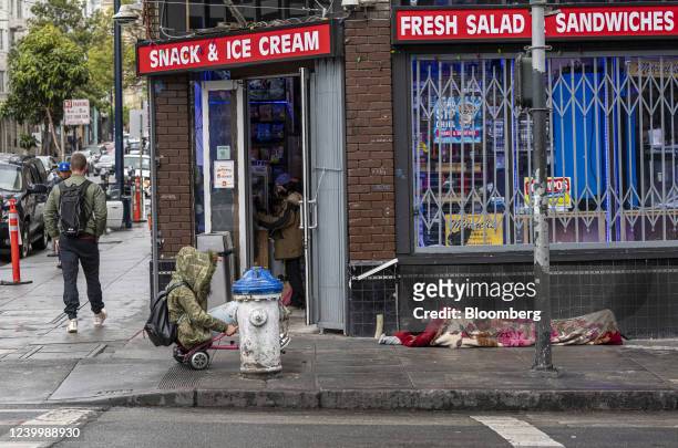 Person experiencing homelessness sleeps on the sidewalk in the Tenderloin district of San Francisco, California, U.S., on Thursday, April 2022. San...