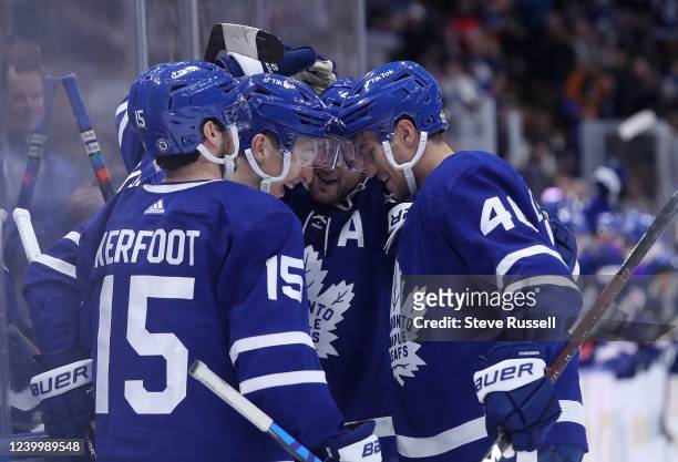 Alexander Kerfoot, Morgan Rielly, and Ilya Lyubushkin congratulate Toronto Maple Leafs right wing Ilya Mikheyev , second from left, after scoring in...
