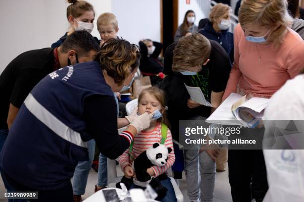 April 2022, Brazil, Mandirituba: A girl from Ukraine undergoes a Corona test after arriving with her mother at a Baptist facility. Two groups of...