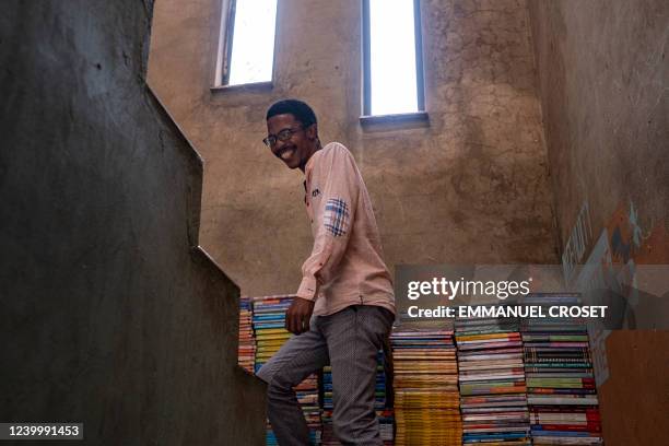 Founder of the Soweto Book Café, Thami Mazibuko walks up the stairs of his home in Soweto on April 5, 2022. In Thami Mazibuko's childhood home, the...