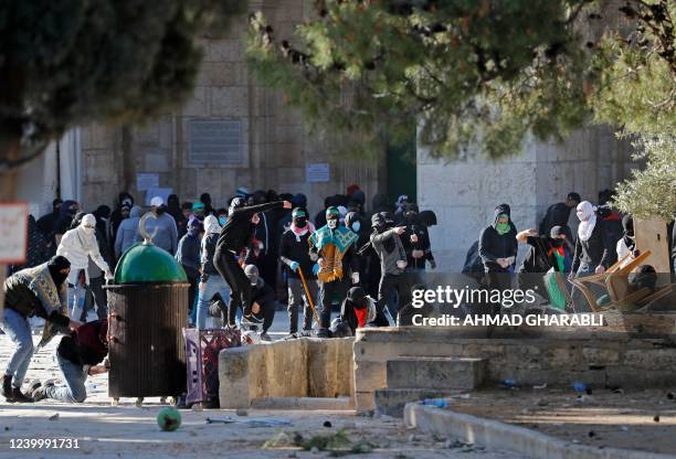 Palestinian demonstrators clash with Israeli police at Jerusalem's Al-Aqsa mosque compound, on April 15, 2022. - Witnesses said that Palestinian...
