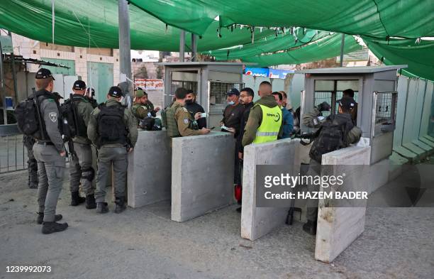 Palestinians try to cross to Jerusalem via the Israeli checkpoint in Bethlehem to pray at the Al-Aqsa mosque compound, on April 15, 2022. - Witnesses...