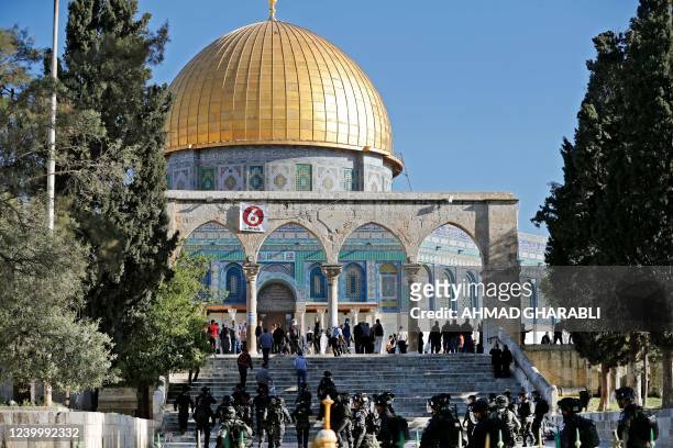 Israeli security forces patrol and Palestinians face each other in front of the Dome of the Rock mosque during clashes at Jerusalem's Al-Aqsa mosque...