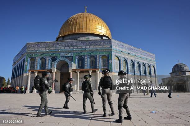Israeli security forces patrol in front of the Dome of the Rock mosque during clashes with Palestinians at Jerusalem's Al-Aqsa mosque compound, on...