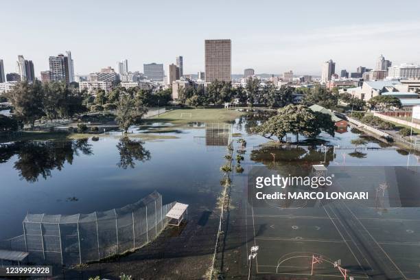This aerial view shows sports fields under water days after heavy rains in Durban on April 15, 2022. - The death toll from South Africa's...