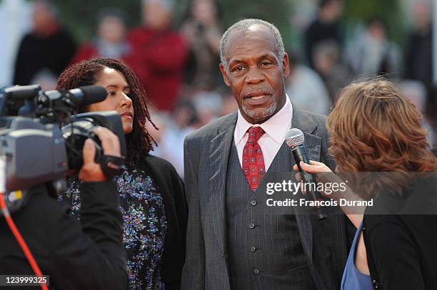 Danny Glover is interviewed as he arrives with Asake Bomani for 'The Conspirator' premiere during the 37th Deauville American Film Festival on...