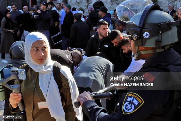 Israeli security forces prevent Palestinians from entering the al-Aqsa mosque compound to attend the Friday prayers, on April 15, 2022. - More than...