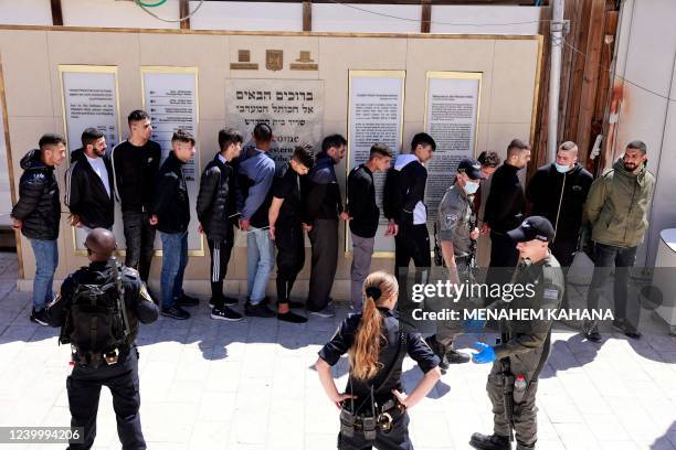 Palestinian youths who took part in a protest at the al-Aqsa mosque compound are arrested by Israeli security forces at the Mughrabi Gate, in the Old...