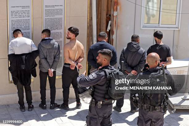 Palestinian youths who took part in a protest at the al-Aqsa mosque compound are arrested by Israeli security forces at the Mughrabi Gate, in the Old...