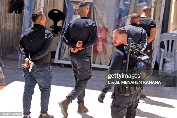 Palestinian youths who took part in a protest at the al-Aqsa mosque compound are arrested by Israeli security forces at the Mughrabi Gate, in the Old...