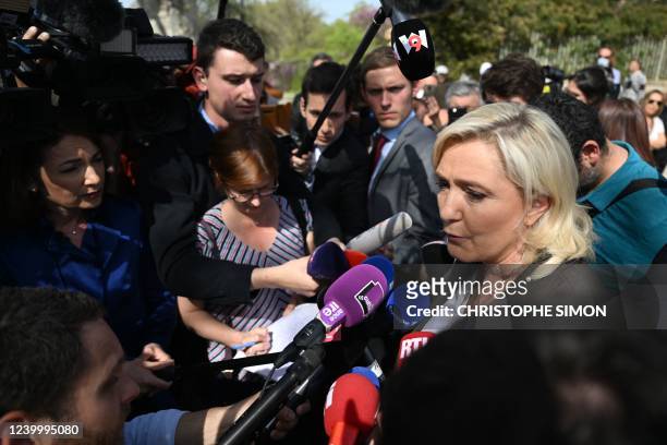 French far-right party Rassemblement National presidential candidate Marine Le Pen addresses media during a campaign visit at Pertuis' market, South...