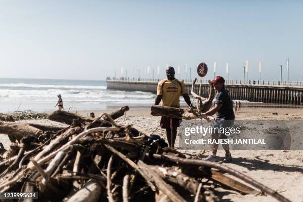 Volunteers and members of the public clean up the massive debris at the North Beach following heavy rains eaelier the week in Durban, on April 15,...