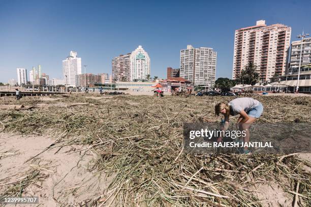 Volunteers and members of the public clean up the massive debris at the North Beach following heavy rains eaelier the week in Durban, on April 15,...