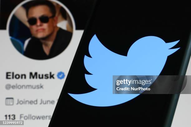 Twitter logo displayed on a phone screen and Elon Musk's Twitter profile displayed on a screen are seen in this illustration photo taken in Krakow,...