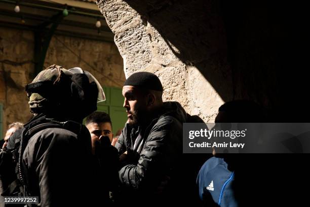 Israeli police officer clashes with a Muslim man near Al -Aqsa Mosque as he attends the second Friday prayer of the Muslim holy month of Ramadan on...