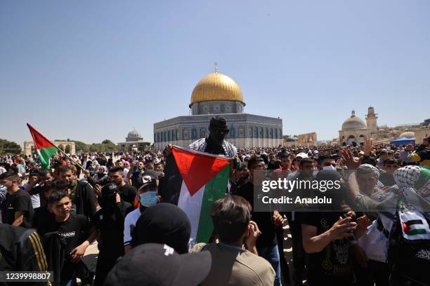 Palestinians chant slogans against Israel after about 60,000 Palestinians performed the second Friday prayers of Ramadan at Al-Aqsa Mosque in...