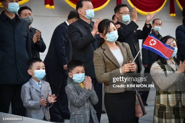 People watch a dancing party in celebration of the 110th birth anniversary of President Kim Il Sung, known as 'Day of the Sun', at Kim Il Sung Square...