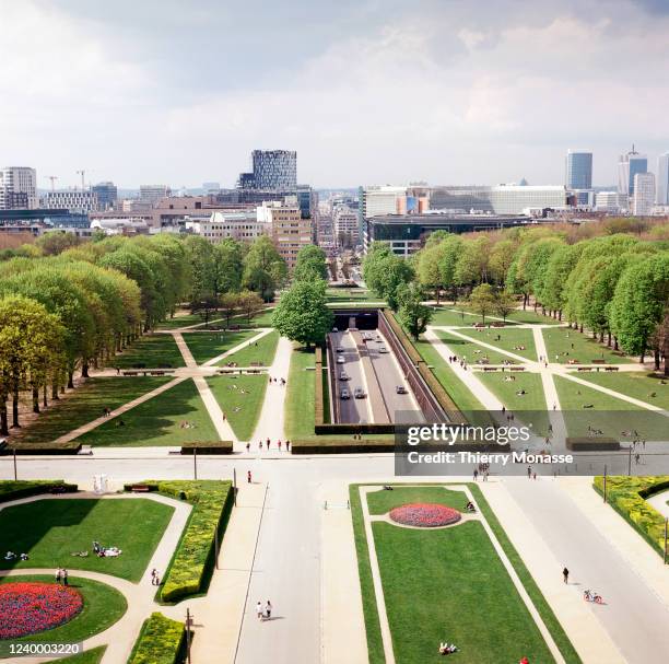 People enjoy the Parc du Cinquantenaire and the Cinquantenaire Arcade on April 14, 2022 in Brussels, Belgium. In the center is the Tunnel...