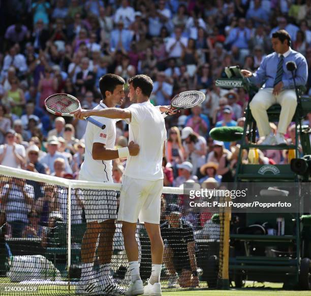 Novak Djokovic of Serbia is congratulated by Grigor Dimitrov of Bulgaria after winning their men's singles semi-final on day eleven of the Wimbledon...