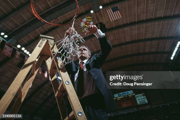 Gary Williams, Head Coach for the University of Maryland Terrapins cuts the net on the backboard hoop to celebrate winning the NCAA Atlantic Coast...