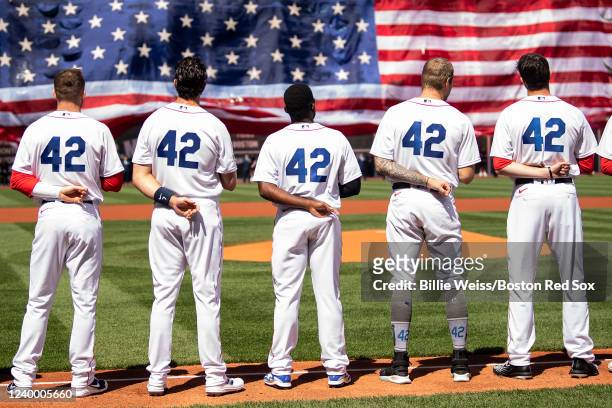 Members of the Boston Red Sox display the number 42 in recognition of Jackie Robinson Day as starting lineups are introduced before the 2022 Opening...