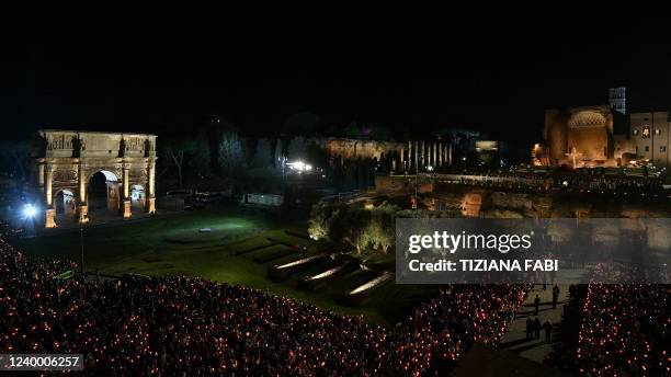 Christian worshippers gather by the Temple of Venus and Rome and the Arch of Constantine to attend the Way of The Cross presided over by the Pope on...