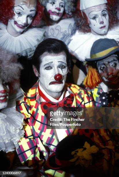 British actor Roger Moore in costume as a clown in his role as James Bond during filming of "Octopussy" at Pinewood Studios in Iver Heath, England in...
