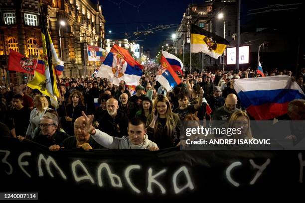 Demonstrators wave Russian and Serbian flags during a march organised by Serbian ultra nationalists organisations in Belgrade on April 15 to protest...