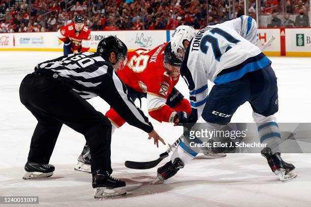 Dominic Toninato of the Winnipeg Jets faces off against Claude Giroux of the Florida Panthers at the FLA Live Arena on April 15, 2022 in Sunrise,...