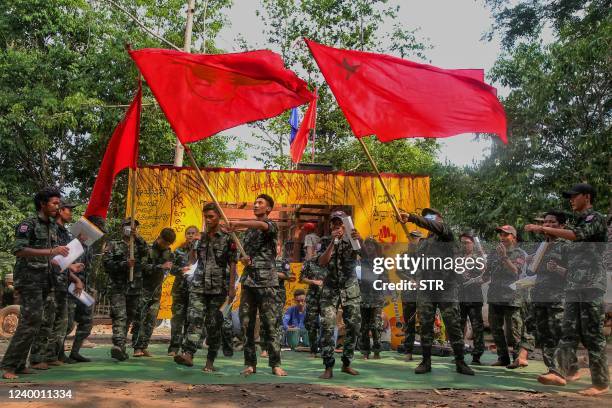 This picture taken on April 15, 2022 shows members of the "Peacock Generation" activist troupe, some of whom are dressed as part of the "People's...