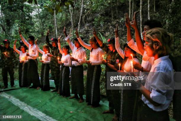 This picture taken on April 15, 2022 shows members of the "Peacock Generation" activist troupe, some of whom are dressed as part of the "People's...