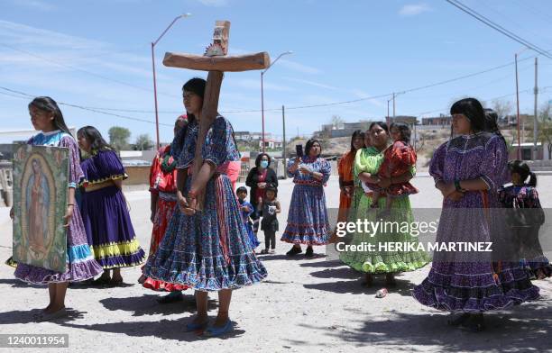 Raramuri indigenous people dressed in their traditional costumes dance to Onoruame during the celebration of the Stations of the Cross on Good Friday...