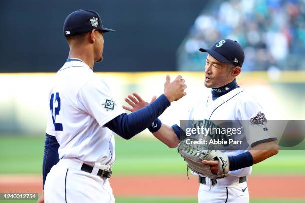 Julio Rodríguez of the Seattle Mariners and former Seattle Mariners Ichiro Suzuki shake hands prior to the game between the Houston Astros and the...