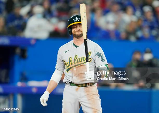 Jed Lowrie of the Oakland Athletics reacts to striking out against the Toronto Blue Jays in the eighth inning during their MLB game at the Rogers...